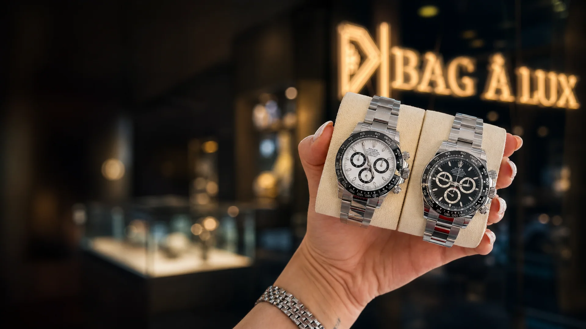 Two Rolex Daytona, panda and black dials, outside the boutique