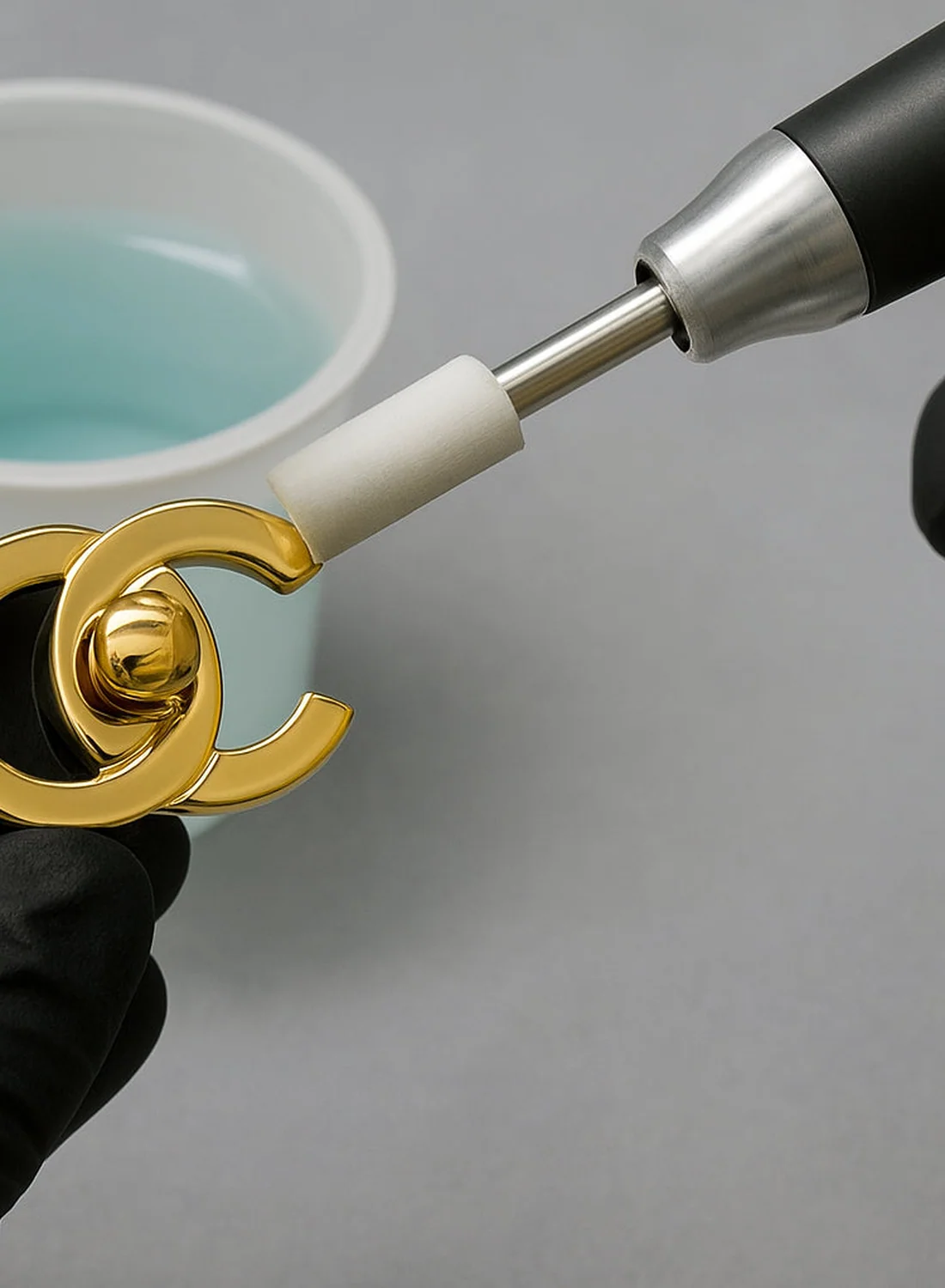 Polishing the gold clasp of a Chanel bag